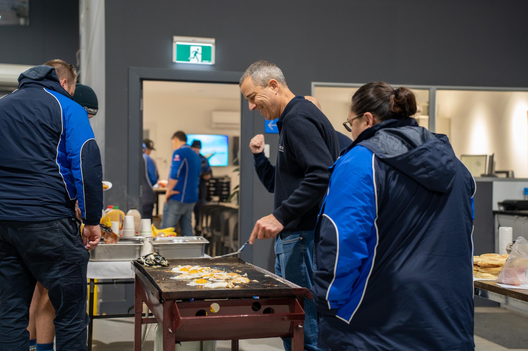The boss cooking up a team breakfast on the BBQ